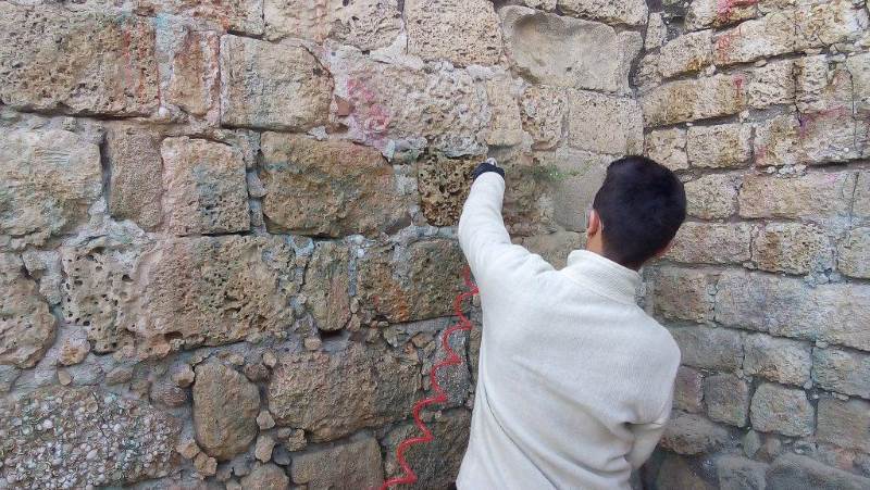 סליחה. העבודות לניקוי קיר המצודה|צילום: אריאל ענבר המלכלכים חזרו לנקות וביקשו סליחה